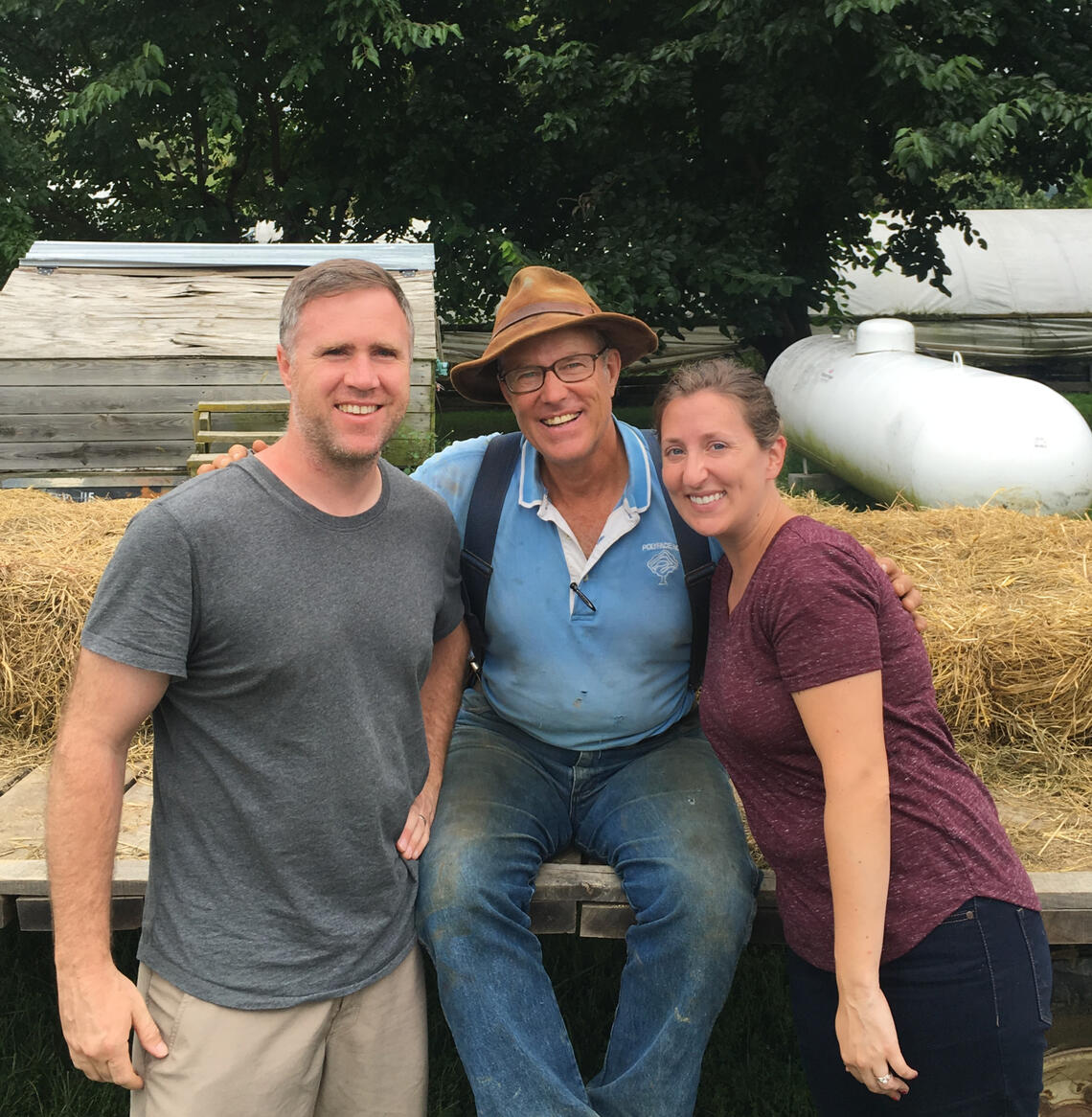 Spencer Shaw, Jen Shaw, and Joel Salatin at a farm